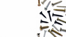 Different Types Of Metal Screws On A White Background, Copy Space And Top View                   