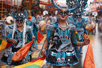 Wall Mural - Diablada dancers in ornate costumes parade through the mining city of Oruro on the Altiplano of Bolivia during the annual carnival.