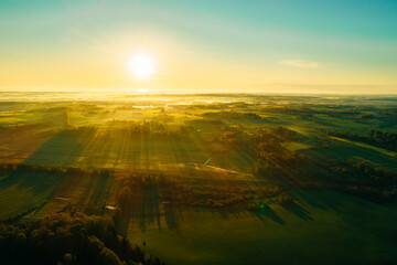 Wall Mural - Green and Yellow agriculture field from above captured with a drone during sunset