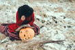 witch grieves over a mask carved from a Halloween pumpkin