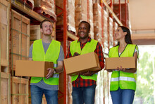 Warehouse Teamwork Worker Holding Cardboard Box Talking Working Together With Happy Moment, Diversity Employee (Caucasian, African, Hispanic).