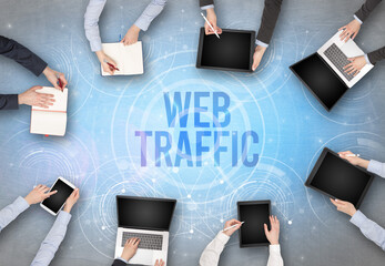 Group of people in front of a laptop with WEB TRAFFIC insciption, web security concept