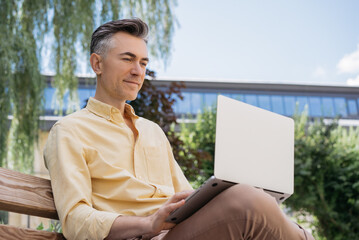 portrait of handsome middle aged writer working, typing on keyboard. serious mature businessman usin