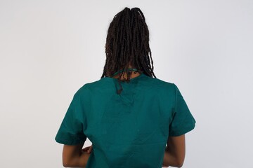 The back side view of a doctor woman wearing medical uniform.