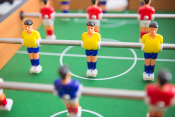 Wall Mural - Table football game with yellow and red players and white goalkeeper.