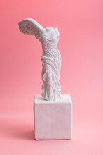 Greek Goddess Of Victory Sculpture On Pink Background