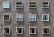 face of cement apartment building with 12 symmetrical windows