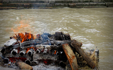 Burning Hindu funeral pyre,Hindu funeral rights of burning the body on a tall wooden funeral pyre in Nepal