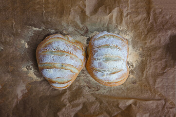 two wheat crispy homemade loaves on a dish