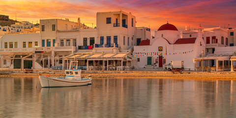 Harbour with wooden fishing boat in Chora town on sunny summer day, Mykonos island, Greece -- Greek landscape. Travel and tourism concept