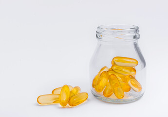 Omega 3 capsules lying on white background.