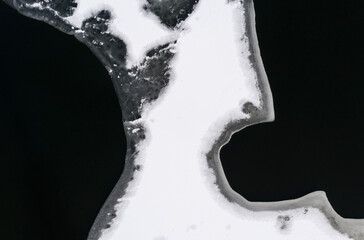 Canvas Print - Flying above ice, top down aerial view of ice floes in the lake.