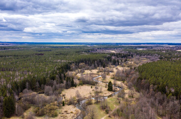 Wall Mural - Drone shot flying on spring river in forest