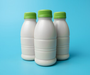 Wall Mural - Bottle of milk on blue color background.