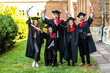 © F8  \ Suport Ukraine - Happy graduates. Five college graduates standing in a row and smiling.