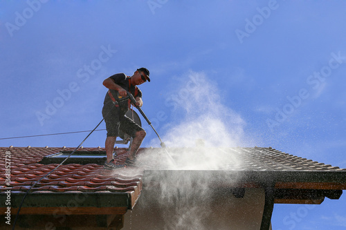 Roof cleaning with high pressure cleaner