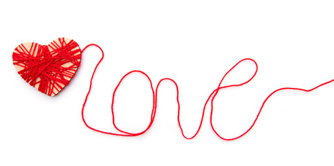 Hearth and word Love made with red thread isolated on white background