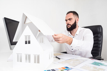 Poster - architect at work. a man is working on a cottage project. concept of a new home. construction of cot