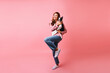 © Look! - Full-length portrait of adorable girl in trendy jeans holding french bulldog. Dreamy caucasian woman posing with her dog on pink background.