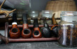 a collection of old briar pipes for smoking on a stand