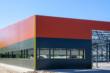 Canvas Print - Metal frame of the new building with a sandwich panel of insulation on the wall