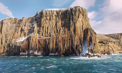 A sea stack beside the cliffs at Neptune's Bellows, a landmark which ships must pass to enter the anchorage at Deception Island in the South Shetland Islands, Antarctica.