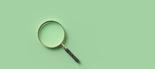Magnification Glass On The Left On Empty Green Background