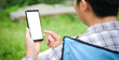 © wattana - Cropped shot view of man hands holding smart phone with blank copy space screen for your text message or information content, female reading text message on cell telephone during in urban setting.