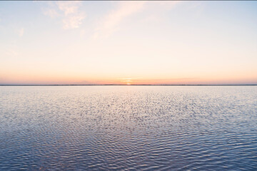 sun sets ha horizon on pink and violet the sky. Pink lake. Striking red pool used in the production of salt near Rio Lagartos, Mexico, Yucatan