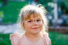 Portrait Of Little Toddler Girl With Ladybug On Face. Happy Smiling Excited Child On Warm Summer Sunny Day.