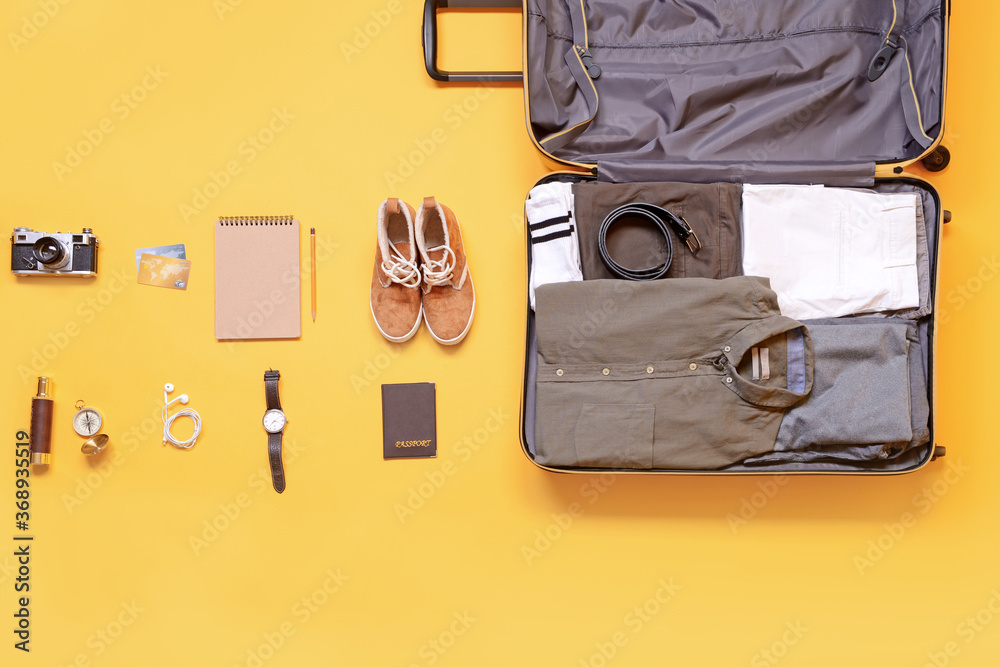 Set of travel accessories on color background