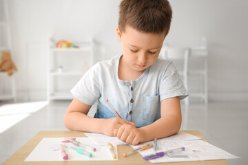 Wall Mural - Cute little boy coloring pictures at home