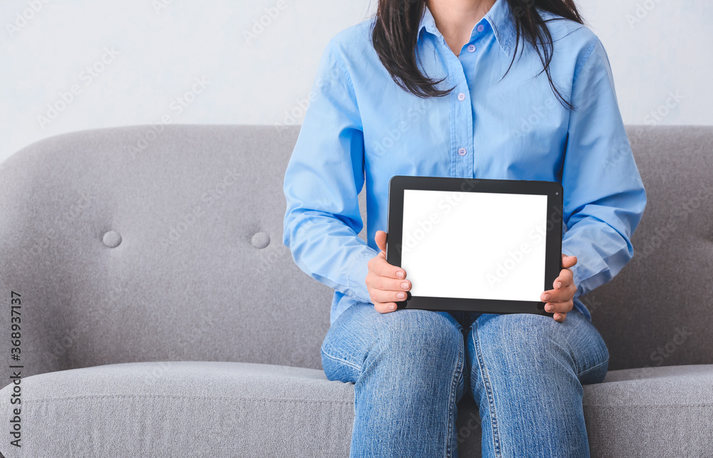 Woman with modern tablet computer at home