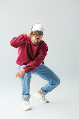 Wall Mural - Male hip-hop dancer on grey background