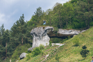 Poster - young hiker man on the top of the cliff