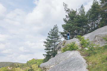 Poster - young hiker man on the top of the cliff