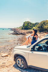 Wall Mural - woman laying at car hood with view of sea summer beach