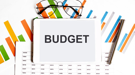Poster - The tablet with text BUDGET on business charts and pen