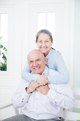 Poster - Elderly woman embracing mature man.