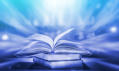 Poster - The blurred book that is bewitched with magic, the magic light in the dark, with the bright light shining down as the power to search for knowledge. For research and use as a blurred background
