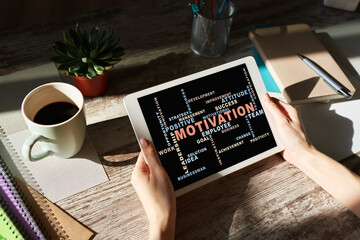 Motivation words cloud on the device screen.