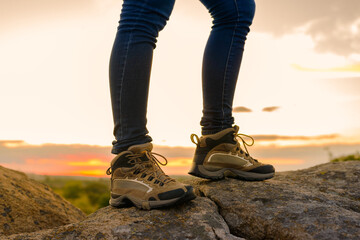 Wall Mural - hiker's legs on the rocky trail at summer sunset. travel and adventure concept.