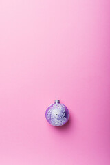 Wall Mural - Christmas violet ball on the pink background