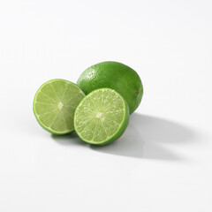 Wall Mural - Closeup of small green key limes isolated on a white background