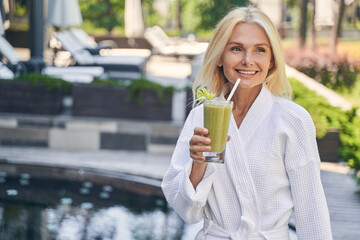 Charming woman feeling happy in the spa hotel on the vacation