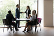 © fizkes - Boss express gratitude shake hands female business coach after seminar corporate training, diverse staff clap hands showing respect. Promoted employee, career advance, loyalty and appreciation concept