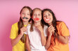 © Luiza - Happy Children hold fake mustache and lips on a pink background. World mental health day.