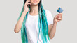 © golubovy - Millennial generation woman with blue hair braids. Cheerful lady verifying credit card personal data on phone unrecognizable isolated on white. Mobile banking. Cashless payment. Customer support.