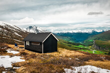 Black Wooden Cabin In Norway Mountains
