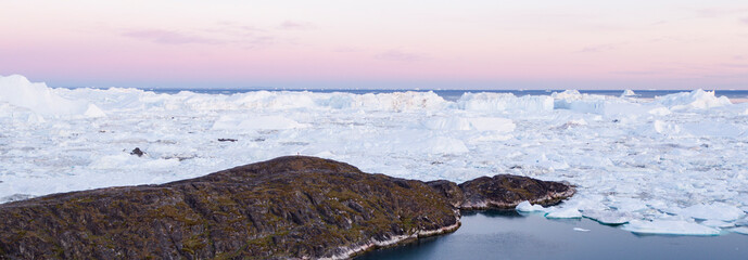 Wall Mural - greenland landscape nature with icebergs and ice in greenland icefjord. aerial drone panoramic banne